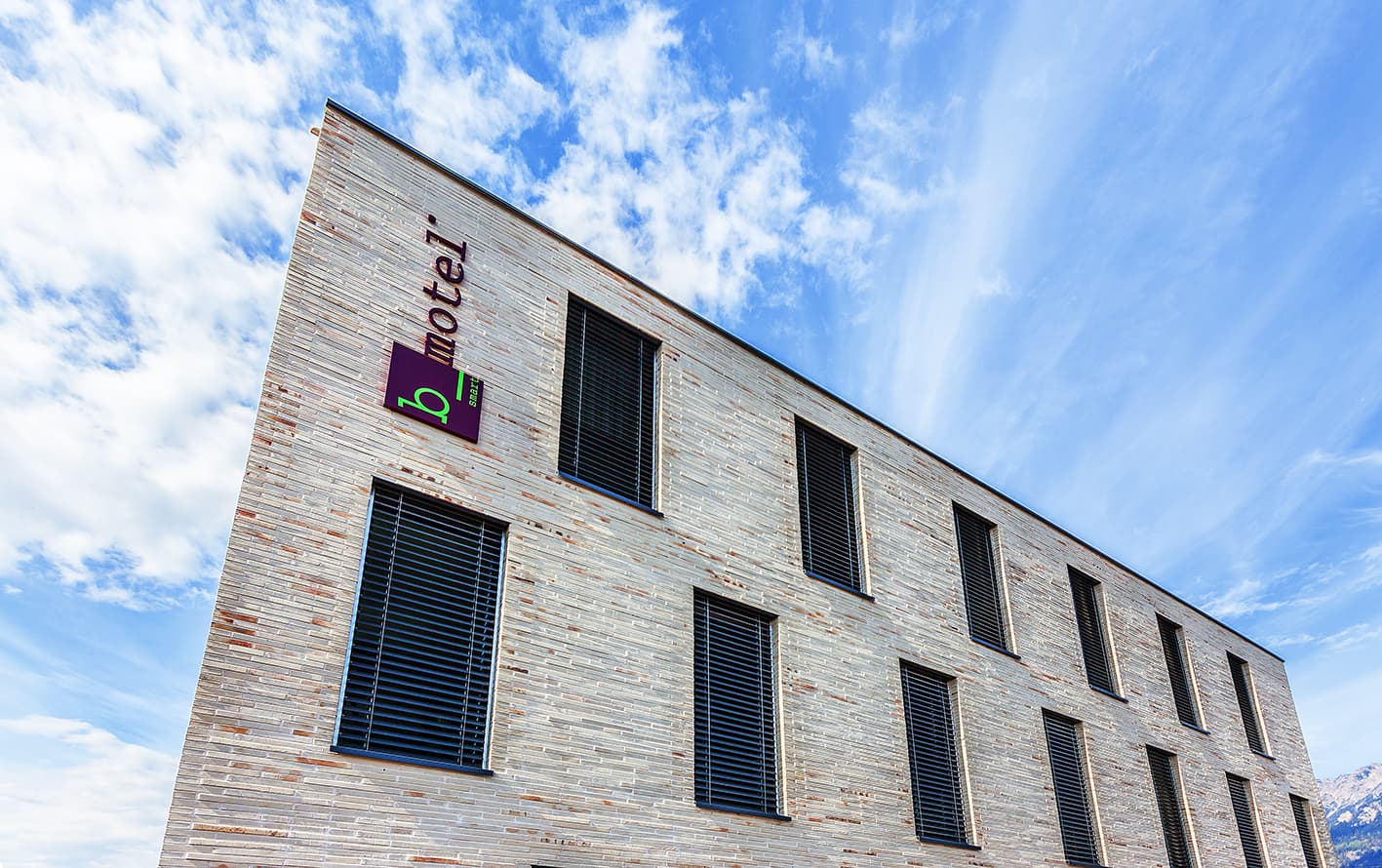 Modern building of the b_smart motel in Sevelen with blue sky in the background