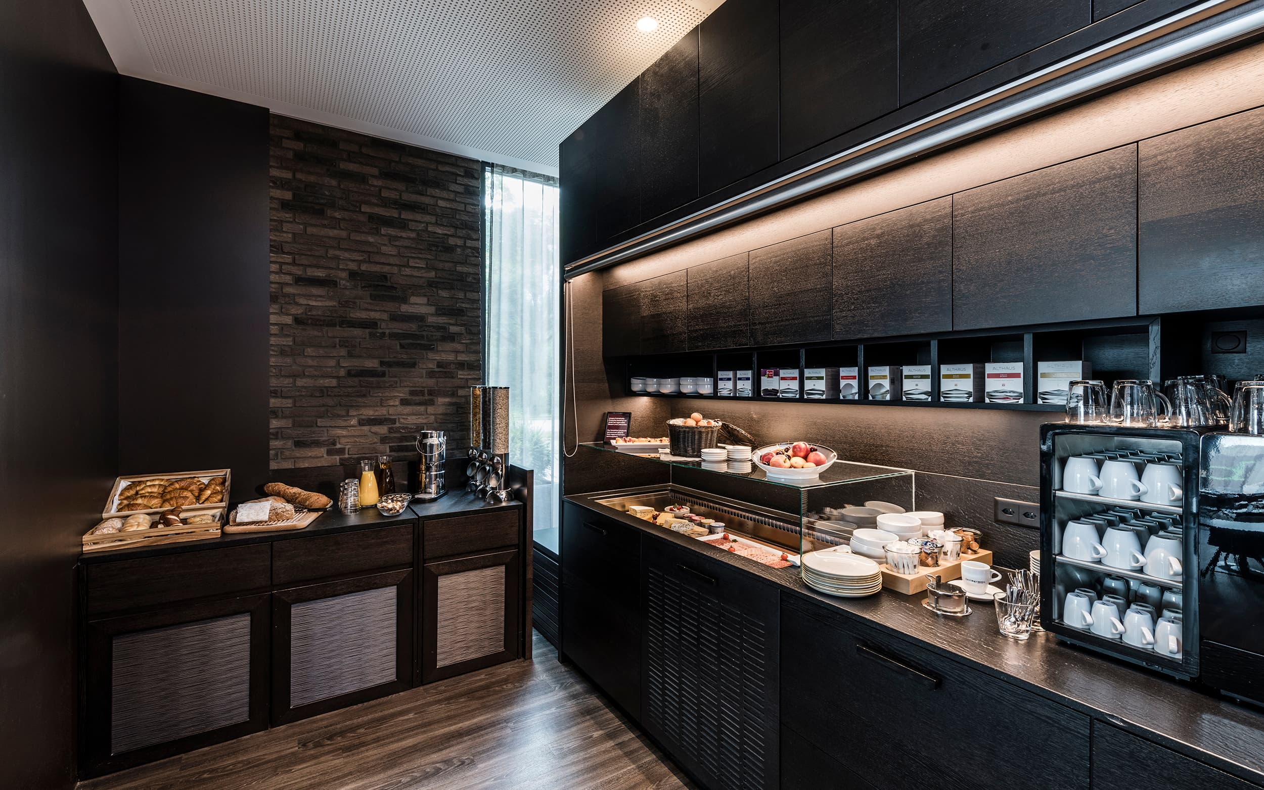 A modern breakfast buffet at the B_smart Hotel Bendern with a selection of pastries, cheese, fruit, juices, and dishes.