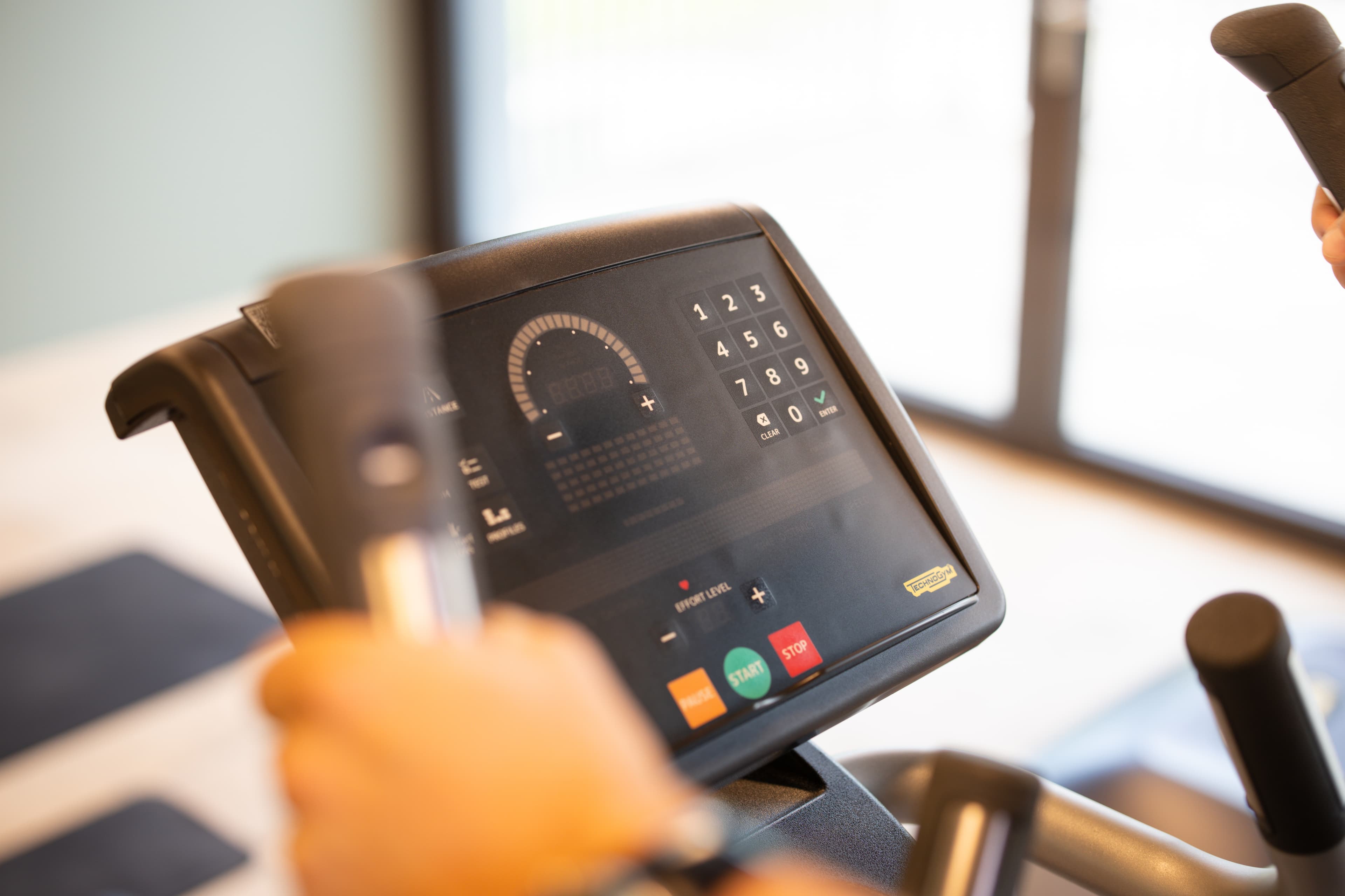 A fitness machine in the B Smart Hotel Widnau with a digital control panel and two handles